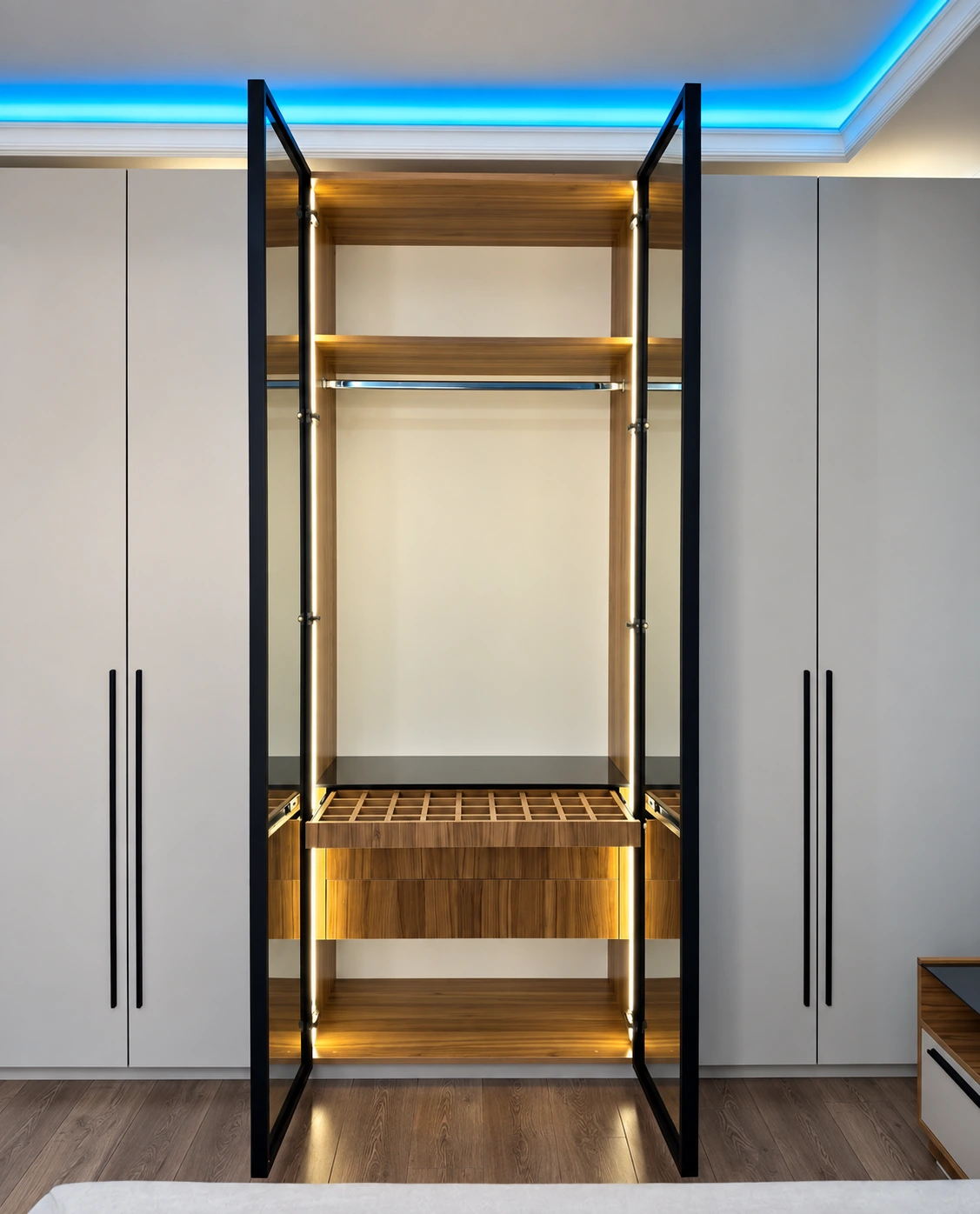 Central wardrobe doors open to reveal hanging rails, lower storage and vertical lighting